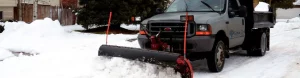 Snow plow blade in front of truck